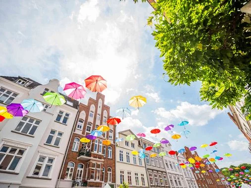 panoramic shot of an umbrella art decoration in an old town